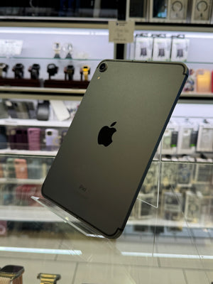 Black Apple iPad on a stand with a store shelf in the background