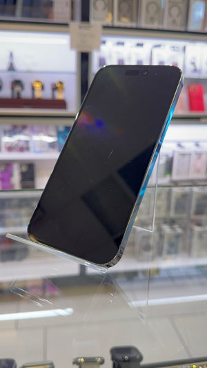 Smartphone on display in a store with blurred shelves in the background