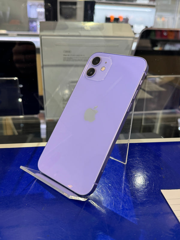 Purple iPhone on a stand with a blurred indoor background