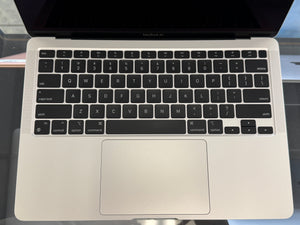 MacBook Air laptop with black keyboard on a reflective surface