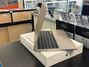 Silver laptop on a white box in a store setting