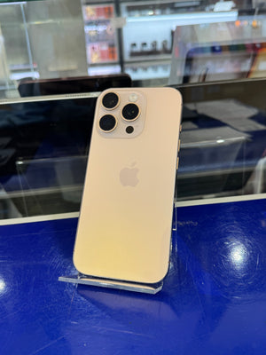 White iPhone with a three camera system standing upright on an acrylic stand in a store setting