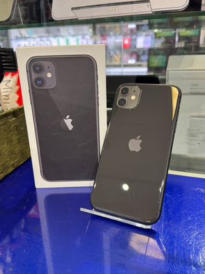 Black iPhone on a stand against iPhone packaging