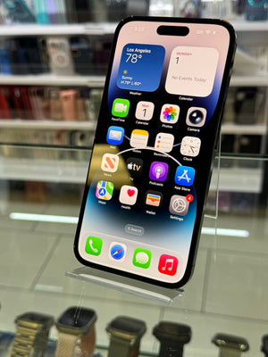 Smartphone with app icons displayed on a glass surface