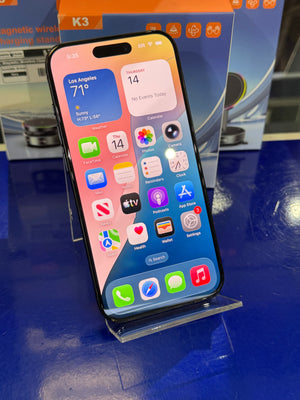 Smartphone with app icons displayed on a blue surface