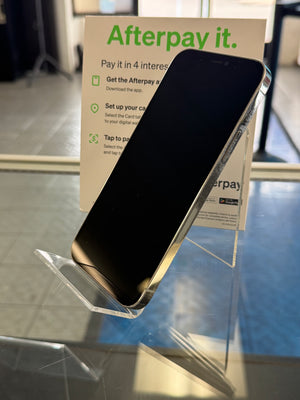 Smartphone on a stand with Afterpay promotional material in the background