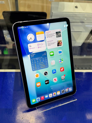 Tablet device with a colorful display of app icons on a blue surface