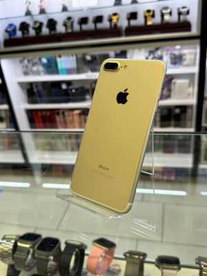 Gold iPhone on display in a store with blurred background
