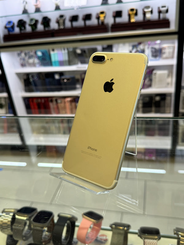 Gold iPhone on display in a store with blurred background