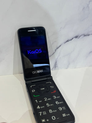 A dark Alcatel flip phone resting against a marble background.  The screen displays blue lettering. 