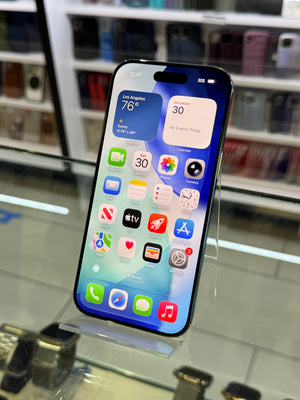 Smartphone with app icons displayed on a reflective surface