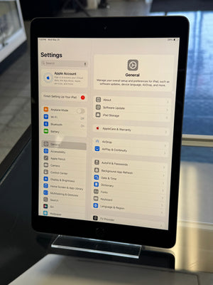 Tablet displaying a settings menu on a blurred background