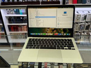 MacBook Air on display in a store in the background