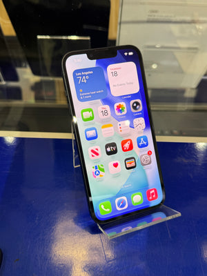 Smartphone with app icons displayed on a stand against a blue surface