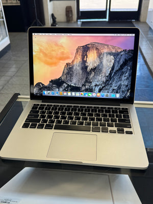 Laptop with mountain-themed wallpaper on a desk