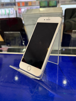 Smartphone with reflective screen held against a blue background