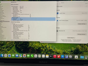 Computer screen displaying battery information and macOS software on a MacBook Air.