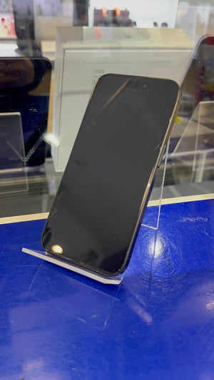 Black smartphone on a blue surface with a clear stand