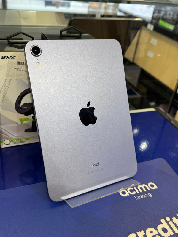 Silver iPad with Apple logo on a blue surface 