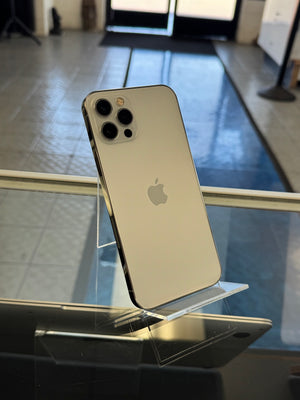 Silver iPhone with Apple logo on a reflective surface