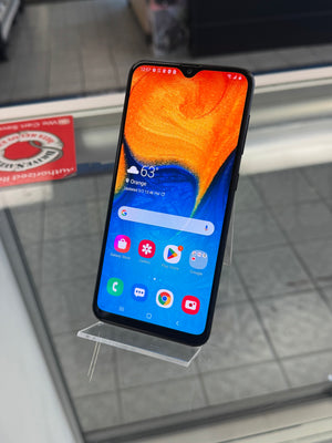 Smartphone on a stand with a colorful display, placed on a reflective surface.