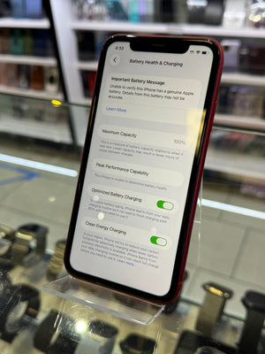 Phone screen displaying battery health and charging information with a blurred background