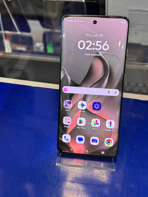 Smartphone on a stand with a reflective blue surface