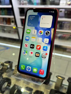 Smartphone with app icons displayed on a stand in a store setting