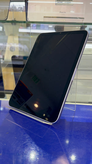 iPad on a reflective surface with a blurred background