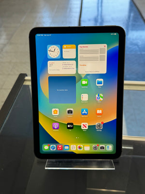 Tablet with a colorful display of app icons on a reflective surface