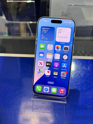 Smartphone with app icons displayed on a stand against a blue background