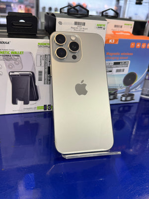 Silver iPhone with Apple logo on a blue surface with product packaging in the background