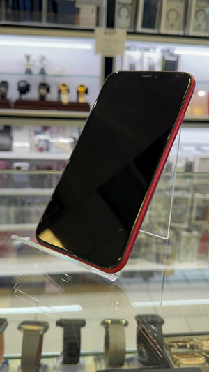 Red iPhone on a stand in a store setting