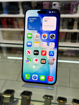 Smartphone with app icons displayed on a reflective surface
