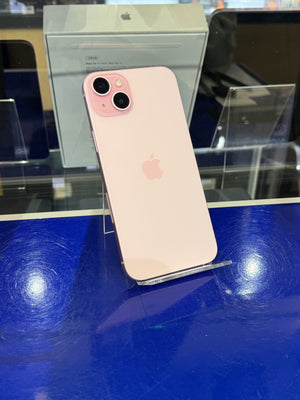 Pink smartphone on a blue surface with an Apple logo
