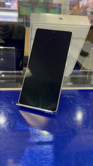Smartphone on a stand with a blue surface and blurred background
