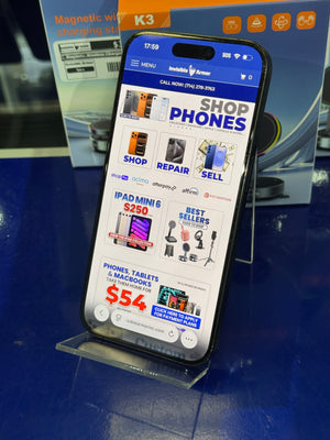 Phone screen displaying a shopping app with various product categories on a blue surface.