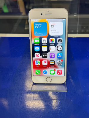 Smartphone with app icons displayed on a blue surface