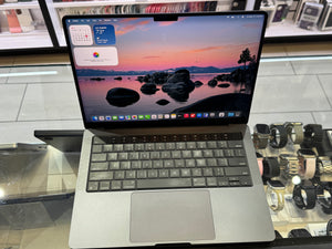 Laptop on a glass table with a colorful screen display