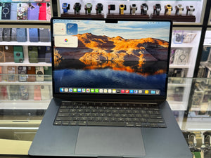 Laptop with a scenic display on a glass table in a store setting