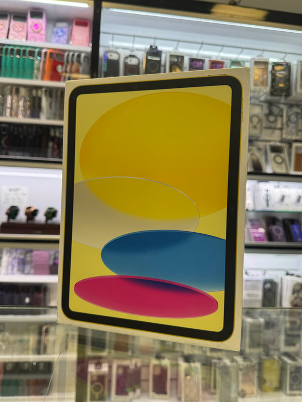 An Apple iPad product box standing upright on a glass display counter inside a retail store.