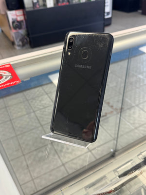 Black Samsung smartphone on a stand with a blurred background