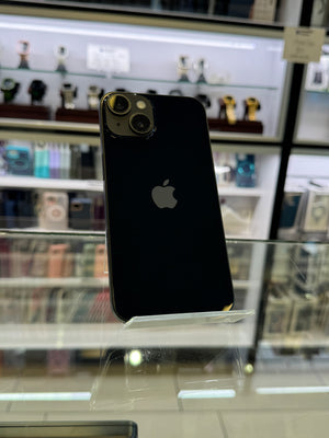 Black smartphone with Apple logo on a stand in a store setting
