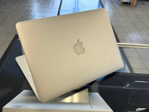 Laptop with Apple logo on a stand in an indoor setting