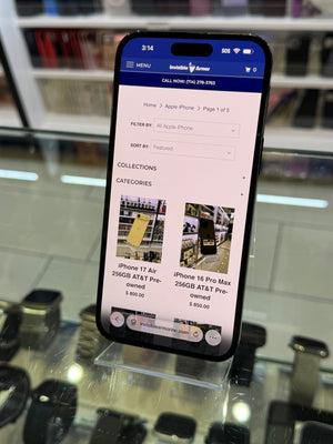 Smartphone displaying a shopping app on a glass surface with blurred background