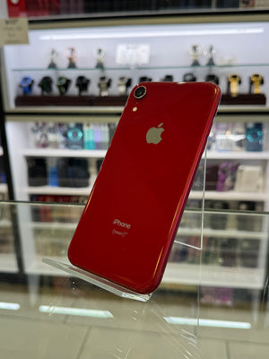 Red iPhone XR on display in a store with blurred background