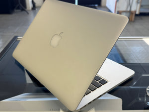 Laptop with Apple logo on a reflective surface