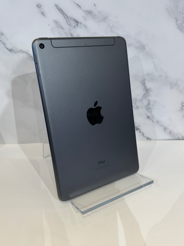 A dark gray Apple iPad standing upright on a clear acrylic display stand against a white marble-patterned background.
