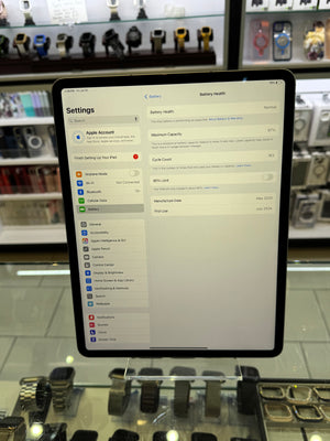 An iPad on display showing a battery settings menu shown in a retail store setting