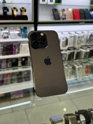 Smartphone with Apple logo on a reflective surface in a store setting